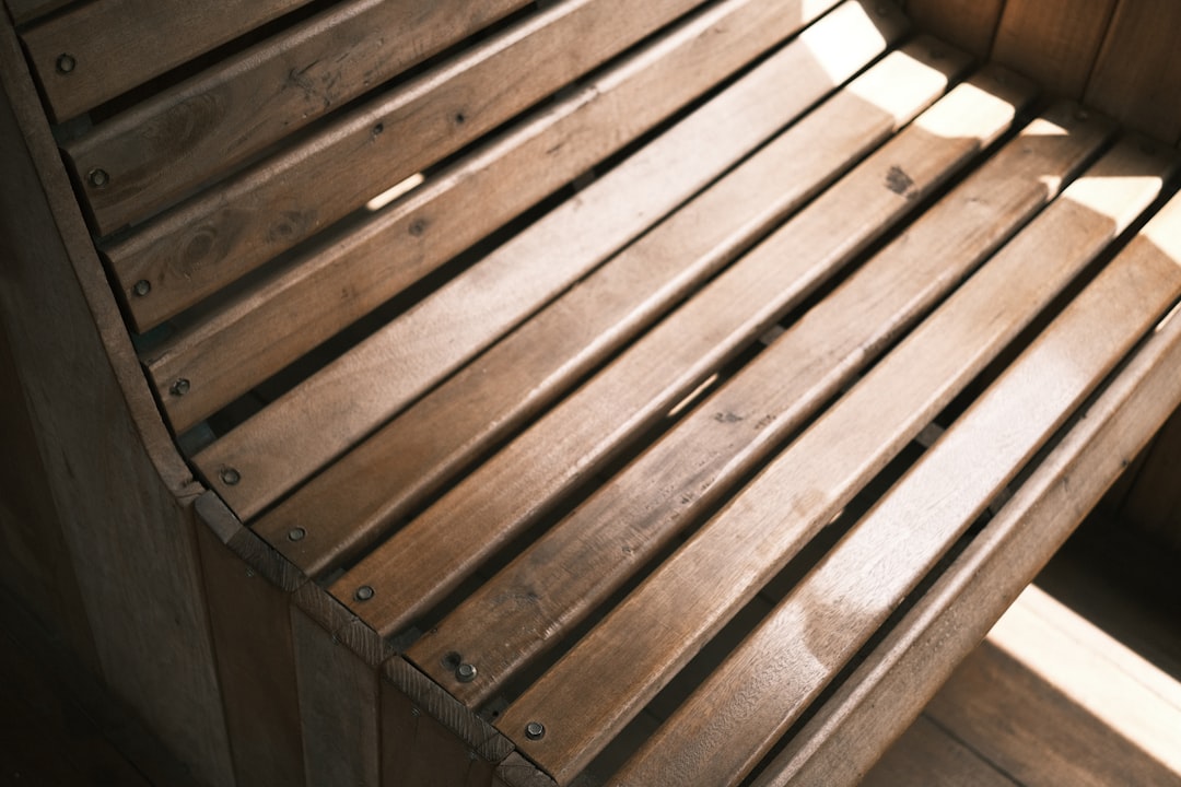 Close-up view of a wooden hot tub seat with slats and soft lighting